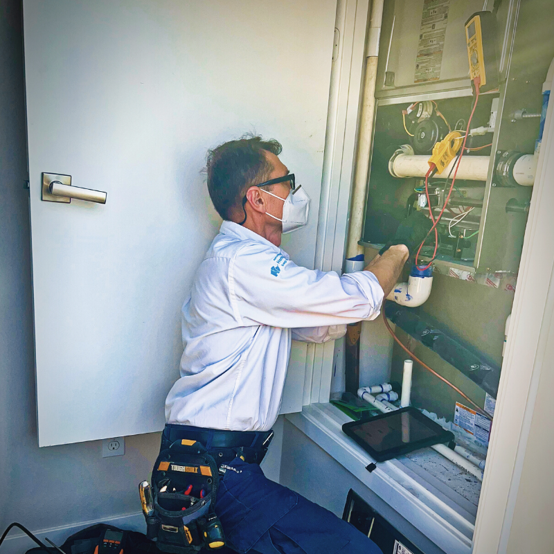 One of our workers configuring important features in our air conditioning systems.